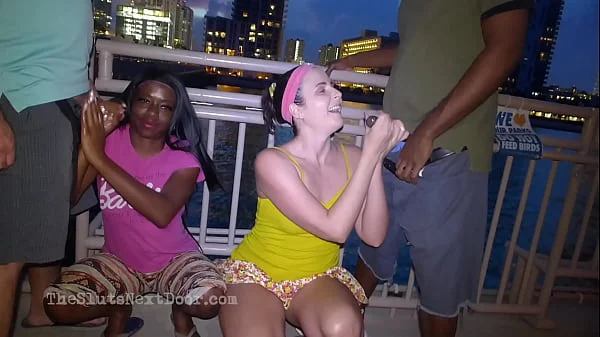 Double handjob on public beach