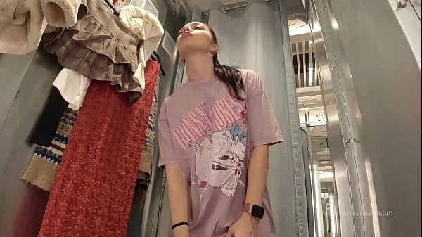 I try on clothes in fitting room with open curtain.