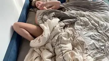 A young student woke up after a wild night and brought herself to orgasm.