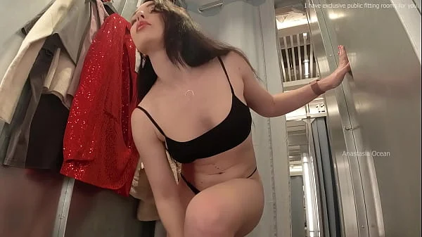 I try on clothes in fitting room with open curtain.