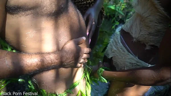 2 African tribe girl having fun with the village chief in the middle of the forrest