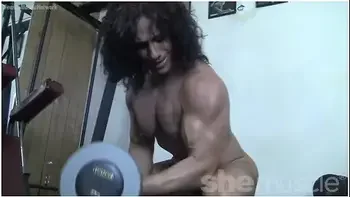 Mature Female Bodybuilder Poses In The Gym