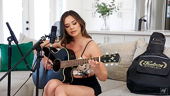 Two hot babes have fun with a guy on the sofa, showcasing sensual moves.