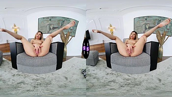 A blonde girl rubs her shaved pussy on the sofa in virtual reality