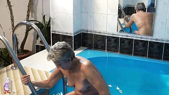 Gorgeous mature blonde Jitka is touching her shaved pussy in the pool