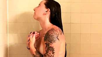 Busty babe playing with her big boobs