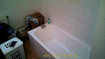 Brunette relaxes in bath and plays with her body